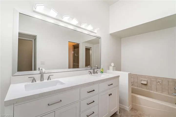 Full bathroom with double vanity and a garden tub