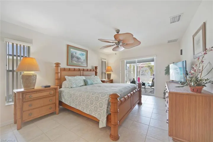 Spacious Primary Bedroom En Suite with Sliders going out to lanai & pool