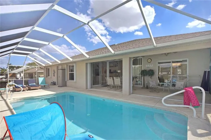Pool, extended lanai and covered eating area under truss