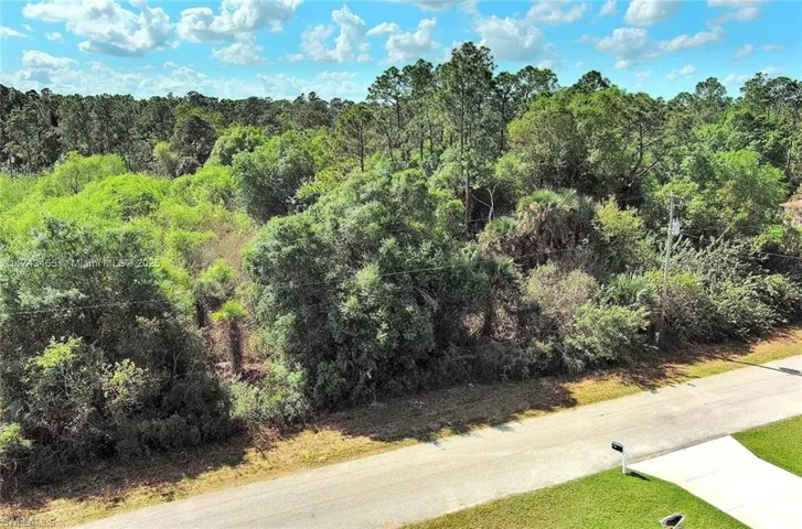 View of asphalt road featuring a view of trees