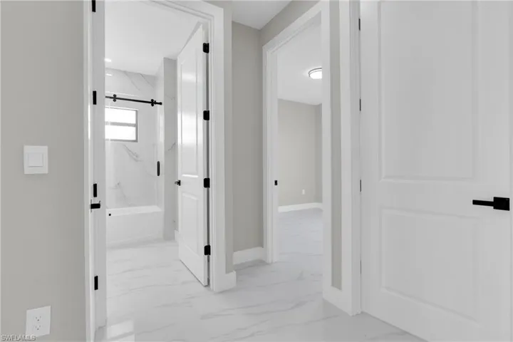 Hallway with light marble finish floors