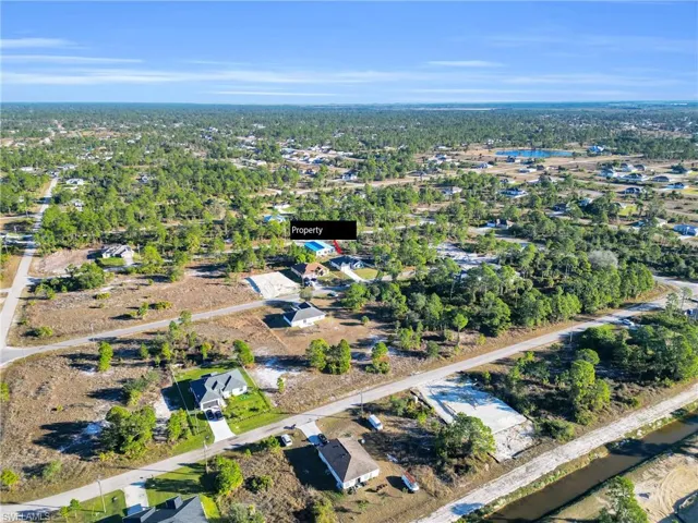 Aerial overview of property's location featuring nearby suburban area