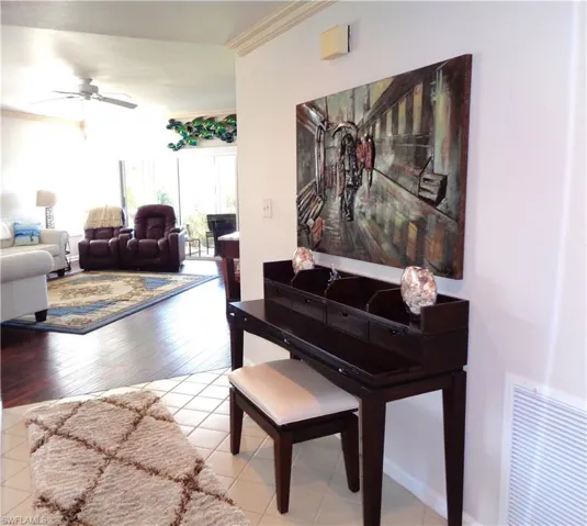 Hall with crown molding and light wood-style floors