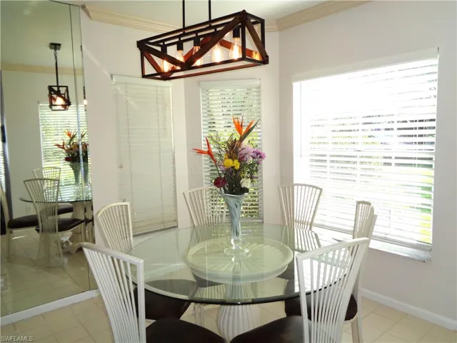 Dining room with ornamental molding and tile patterned flooring