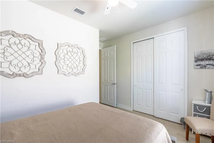Bedroom with light wood-type flooring, a closet, and ceiling fan