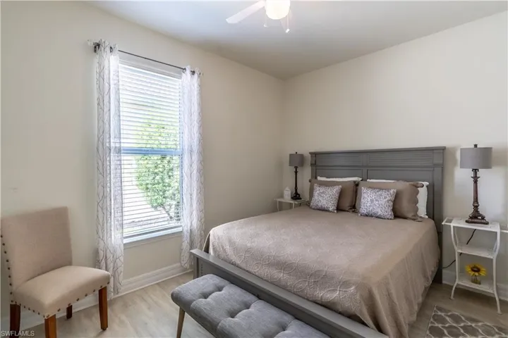Bedroom with light hardwood / wood-style flooring and ceiling fan