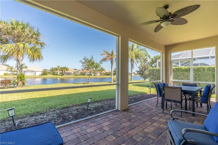 Sunroom with a water view and ceiling fan