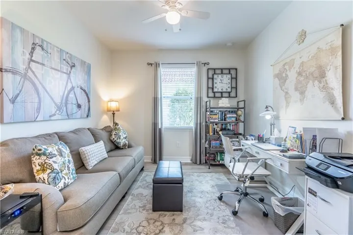 Office area with light hardwood / wood-style flooring and ceiling fan