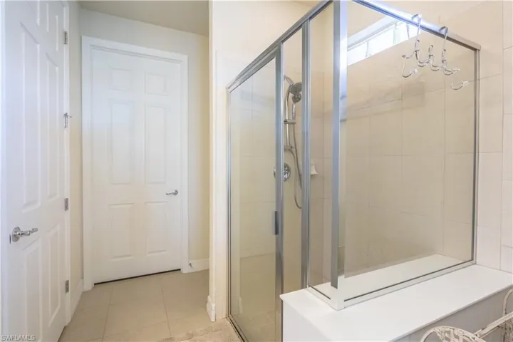 Bathroom with tile patterned flooring and an enclosed shower