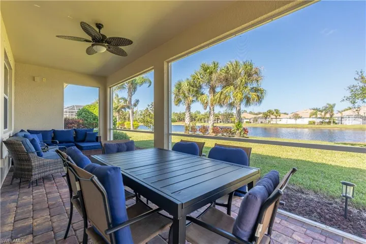 View of patio / terrace with an outdoor living space, a water view, and ceiling fan