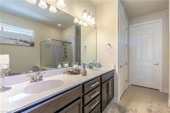 Bathroom featuring vanity, an enclosed shower, and tile patterned floors
