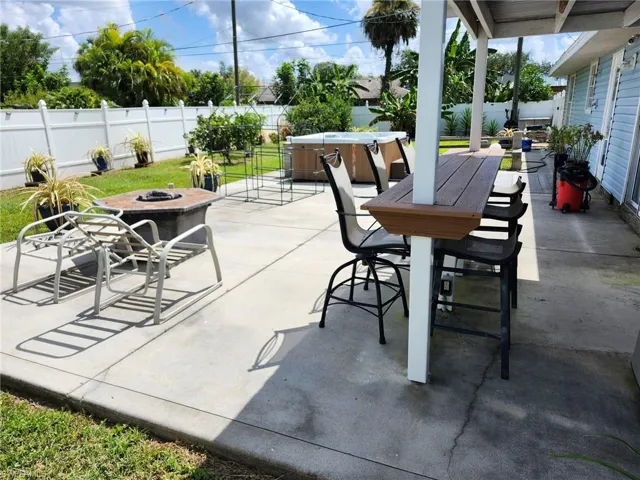 View of patio / terrace with a fire pit and a hot tub