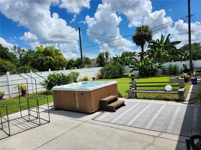 View of patio / terrace with a hot tub