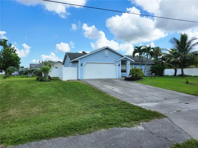 Single story home featuring a front yard and 2 car garage