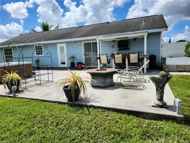 Rear view of home with an outdoor fire pit and a patio area