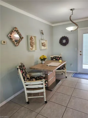 Tiled dining space with crown molding