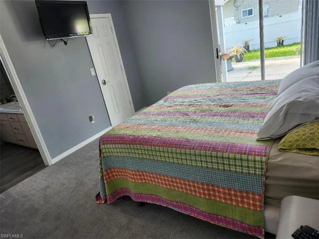 Primary Bedroom with hardwood / wood-style floors and access to exterior