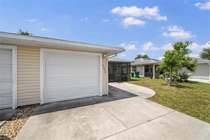 Single-car garage with white panel door