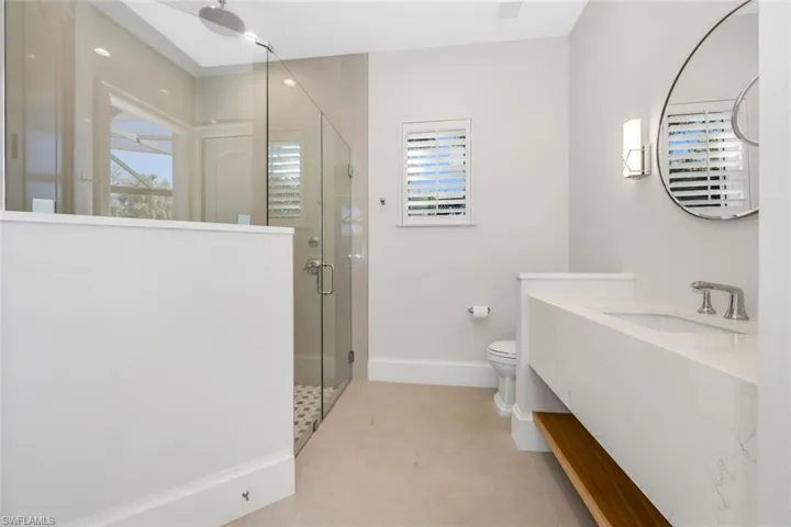 Bathroom featuring a shower stall and vanity