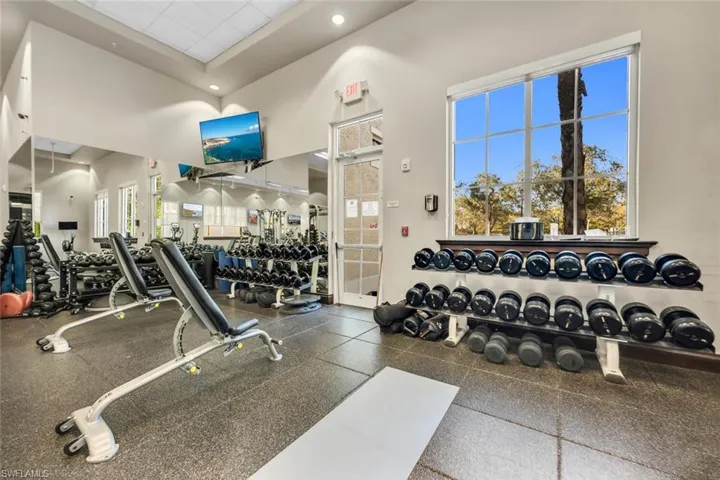 Workout area featuring a high ceiling and recessed lighting