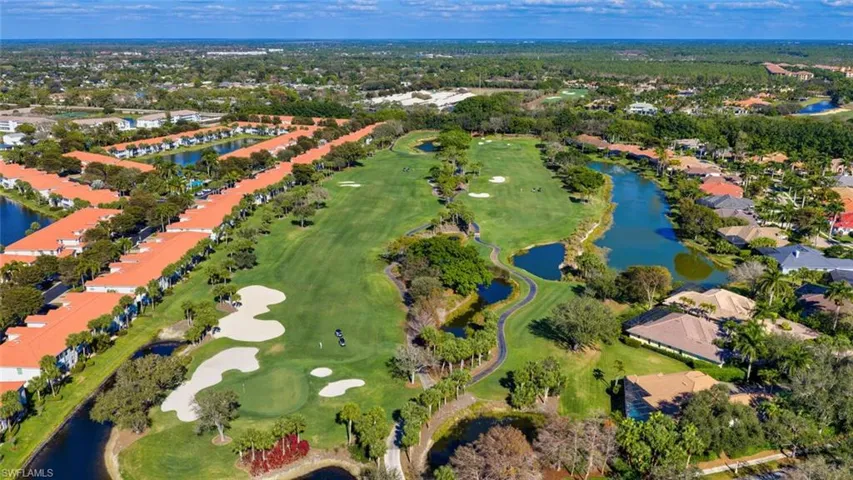 Aerial view of residential area with a large body of water and a local golf course