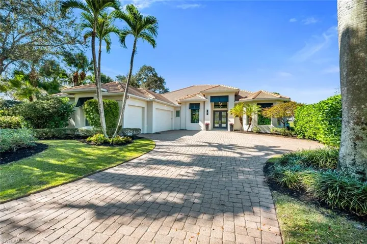 Mediterranean / spanish home with french doors, decorative driveway, a garage, stucco siding, and a tiled roof