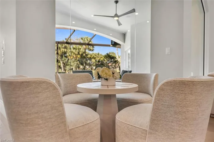 Dining room featuring a sunroom, a ceiling fan, and recessed lighting