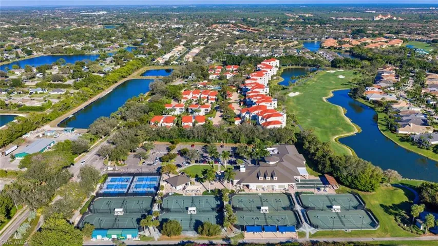 Aerial overview of property's location featuring nearby suburban area, a nearby body of water, and a golf club