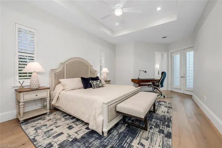 Bedroom featuring light wood-type flooring, recessed lighting, a ceiling fan, access to outside, and french doors