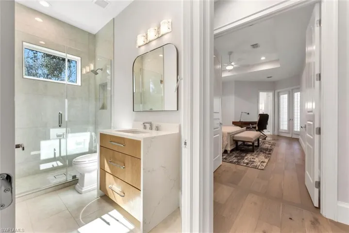 Full bathroom with vanity, recessed lighting, a stall shower, and a ceiling fan
