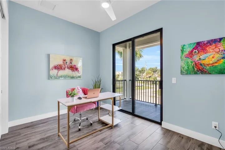 Office area with hardwood / wood-style floors and ceiling fan