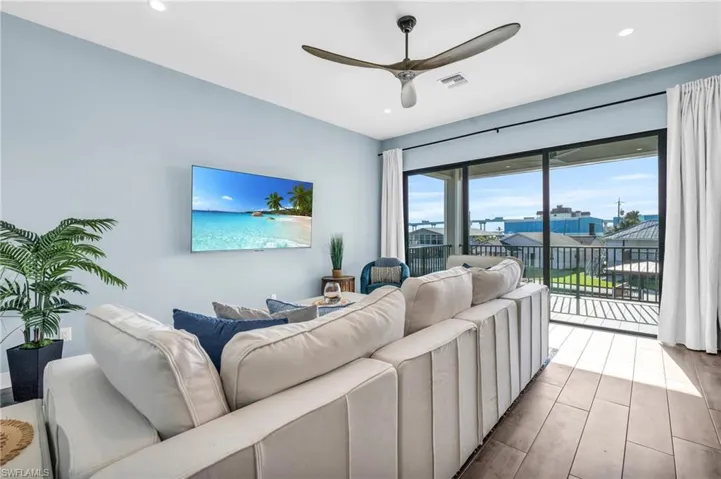 Living room featuring plenty of natural light, ceiling fan, and light hardwood / wood-style floors