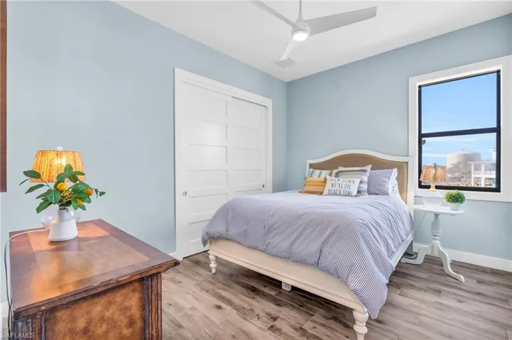 Bedroom featuring ceiling fan, a closet, and light hardwood / wood-style floors