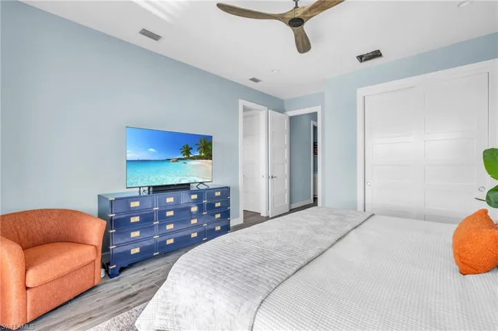 Bedroom with a closet, ceiling fan, and light hardwood / wood-style floors