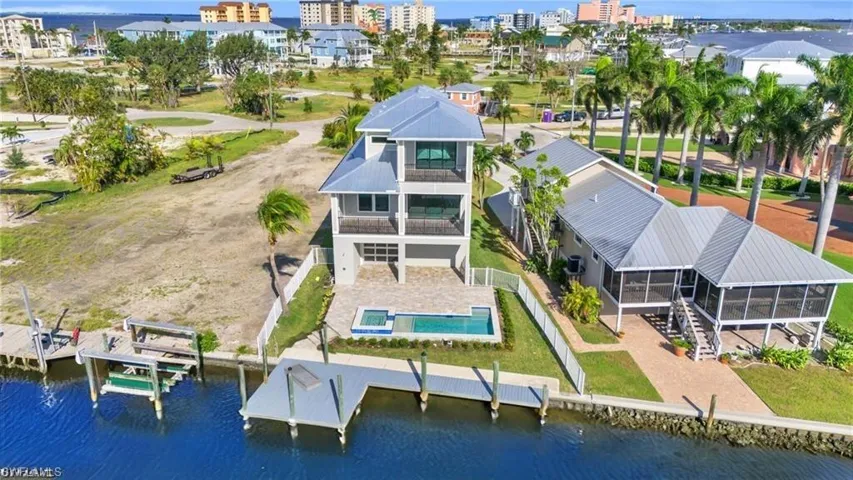 Birds eye view of property with a water view