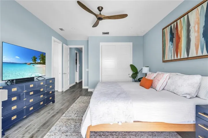 Bedroom with hardwood / wood-style floors and ceiling fan