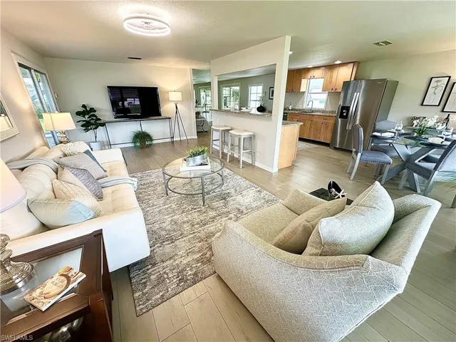 Living room featuring light hardwood / wood-style flooring and a healthy amount of sunlight