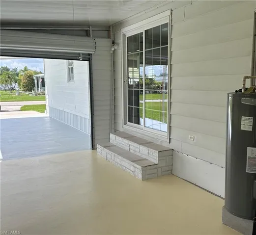 Garage featuring electric water heater