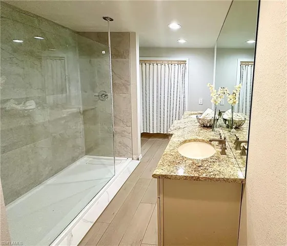Bathroom featuring walk in shower and vanity