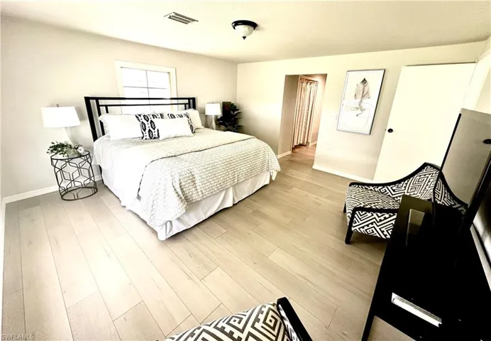 Bedroom with light hardwood / wood-style flooring