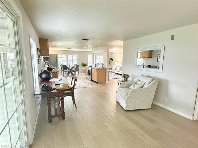 Living room with light hardwood / wood-style floors