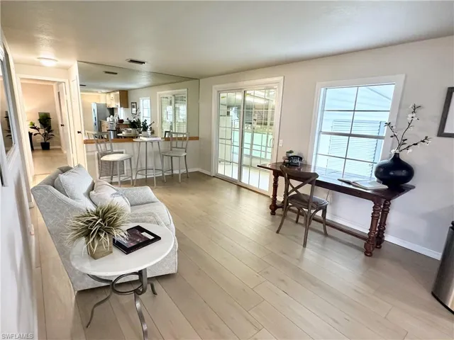 Living room featuring light wood-type flooring and plenty of natural light