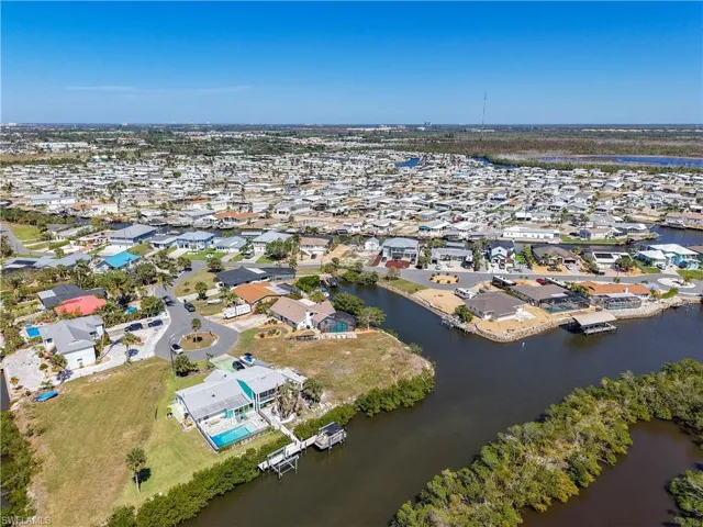 Aerial view of property's location featuring nearby suburban area and a large body of water