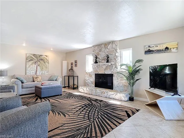 Living area featuring a fireplace and baseboards