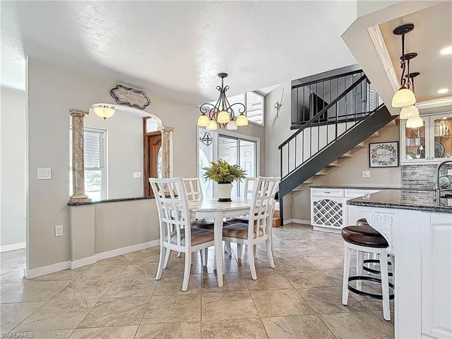 Dining room with a chandelier and stairs