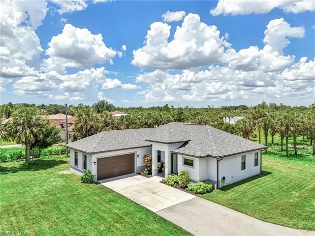 View of front of home featuring a garage and a front yard