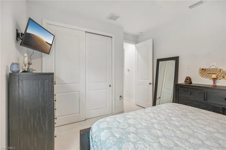 Tiled bedroom featuring a closet