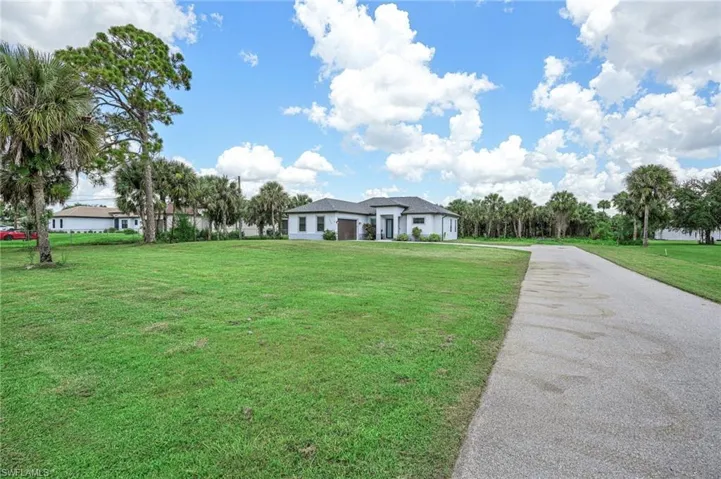 View of community featuring a garage and a yard
