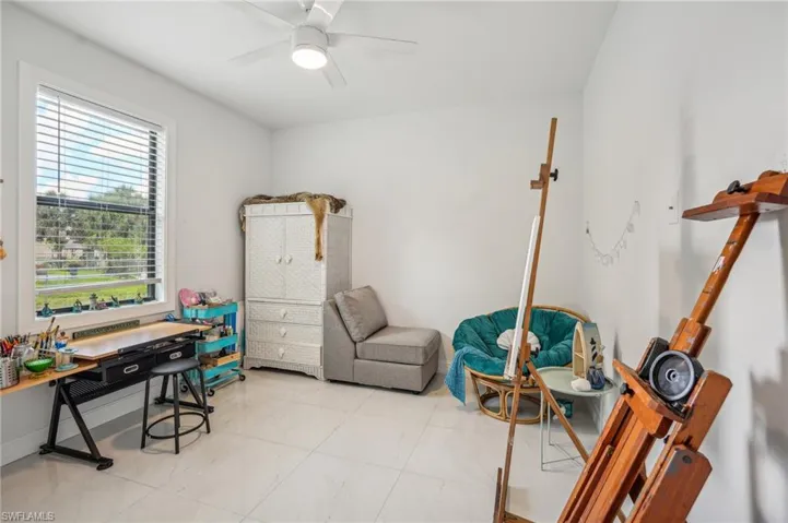 Tiled home office featuring ceiling fan