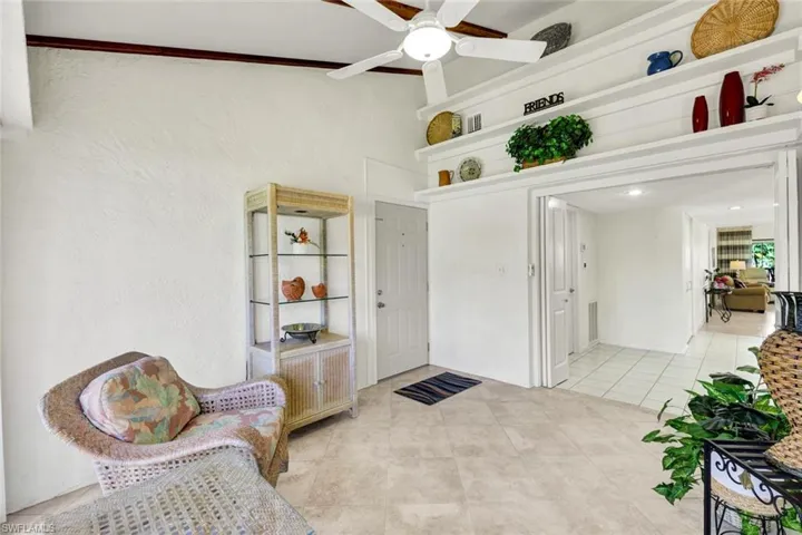 Den with Porcelain Tile Flooring and Glass Sliders- Screened
